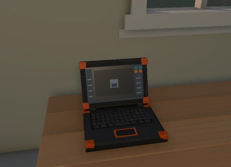 The rugged laptop open on the desk in the garage.