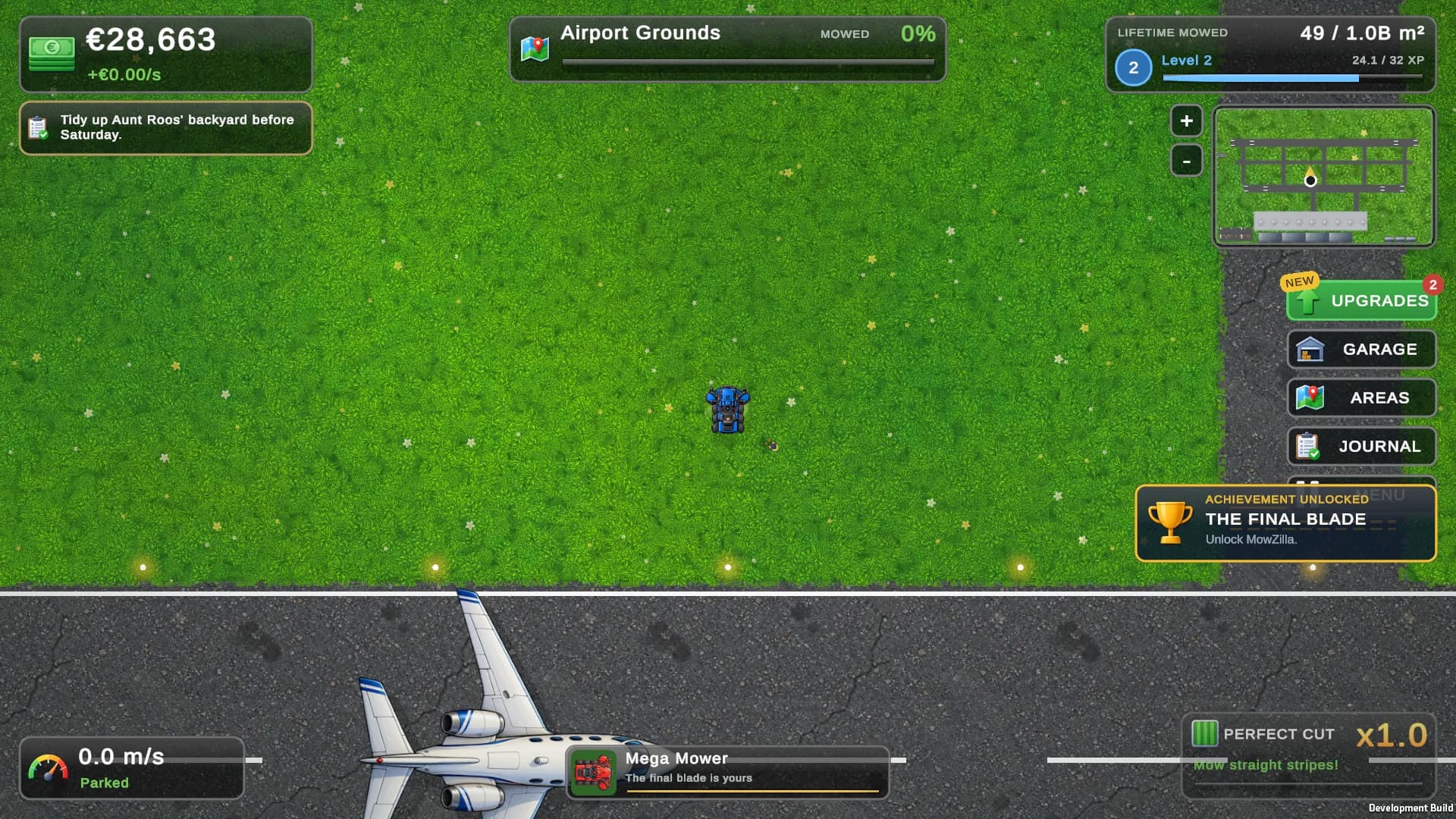 A plane rolls down the runway after touching down, next to the lawn being mowed